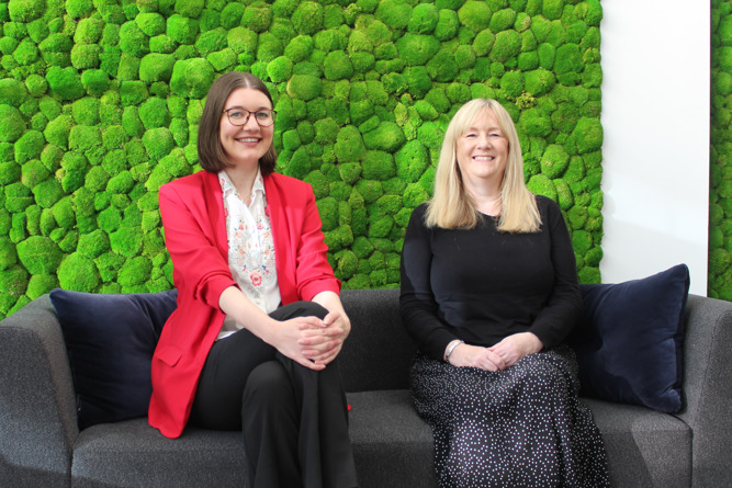 The new NEPO's comms team sitting son sofa smiling at camera