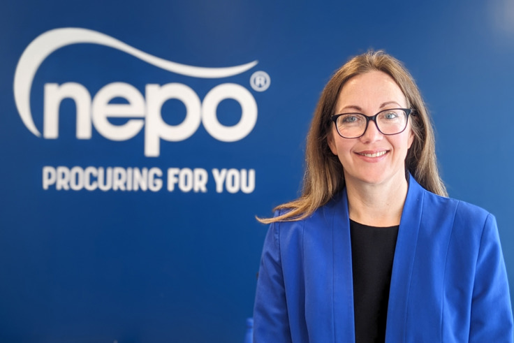 Photo of Victoria Maw stood in front of NEPO signage