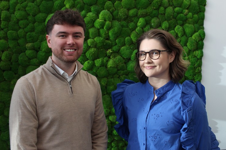 Photo of Liam Shuttleworth, Procurement Lead for Fleet and Building Materials and Bethany Wake, Strategic Advisory Hub Lead stood side-by-side smiling at the camera.