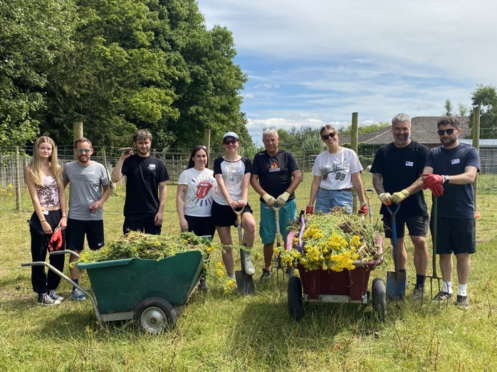 Group shot of the volunteering team after tidying up one of the paddocks, from left to right: Grace Lusby (EDF), James Lusby (EDF), Shae Singh (NEPO), Laura Kyle (NEPO), Rachel Bruce (NEPO), Keith Lamb (NEPO), Marie Forster (NEPO), Darryl Person (EDF), Steven Ridley (EDF)